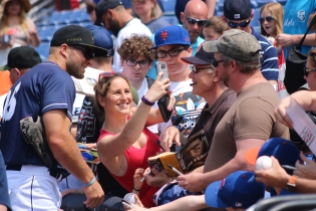 Tebow often poses for Selfies with fans at Binghamton.